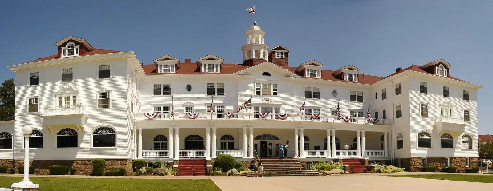The Stanley Hotel's white Georgian facade against the mountains in Estes Park
